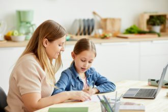 Cute Girl Enjoying Homeschooling with Mom