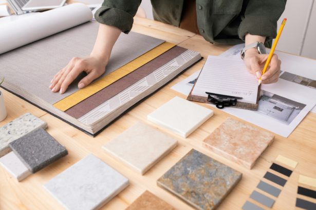 Hands of female interior designer with pencil over paper making notes